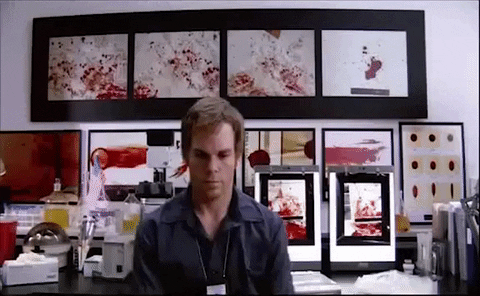 Dexter in a crime lab spinning distractedly in an office chair and thinking about how to Manage Adult ADHD.