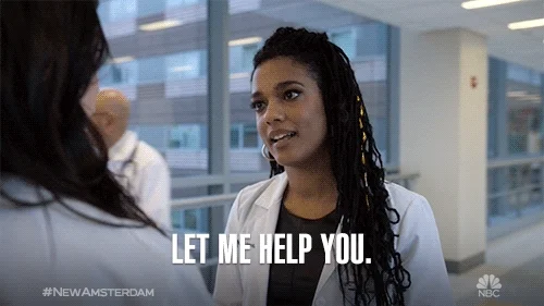 A Black woman in a lab coat at work says to her coworker, 