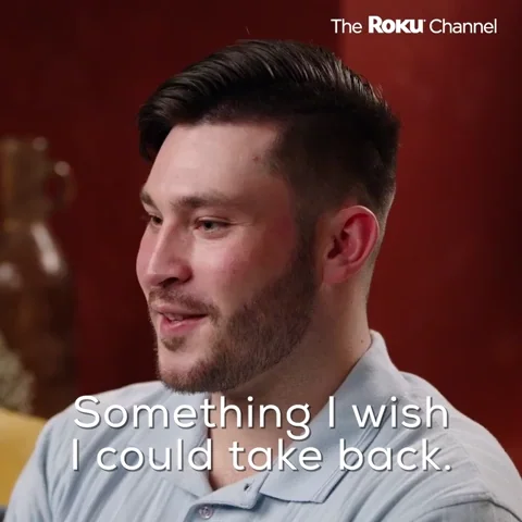 A man smiling uncomfortably with the text 