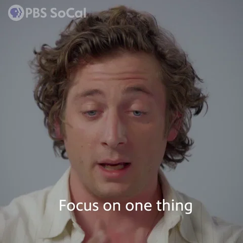 Jeremy Allen White with an intense expression, pointing or nodding while saying 'focus on one thing.'