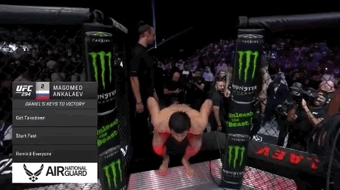An MMA fighter hops into the arena.