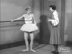 Lucille Ball practising ballet. Her instructor points out her errors with a stick.