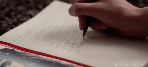 Closeup of the hand of a person writing in a notebook
