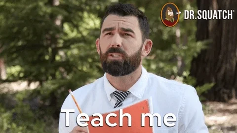 A man standing in an outdoor classroom holding a pencil and notebook saying, 