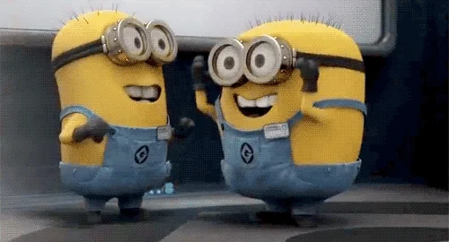 Two minions from the movie Despicable Me expressing and gesturing excitement.