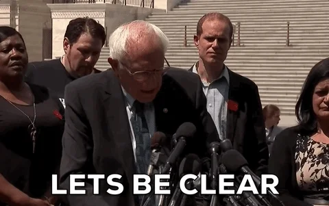 Bernie Sanders in front of microphones saying, 