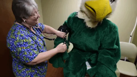 A Doctor checking a person dressed up as a bird