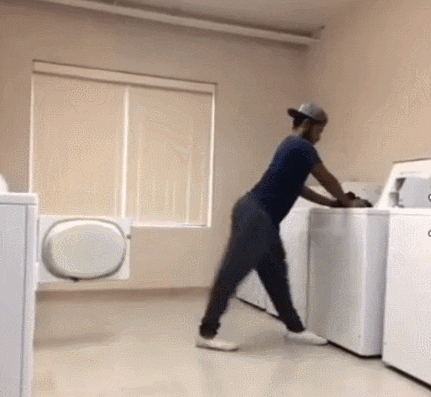 Man moving clothes from washer to dryer