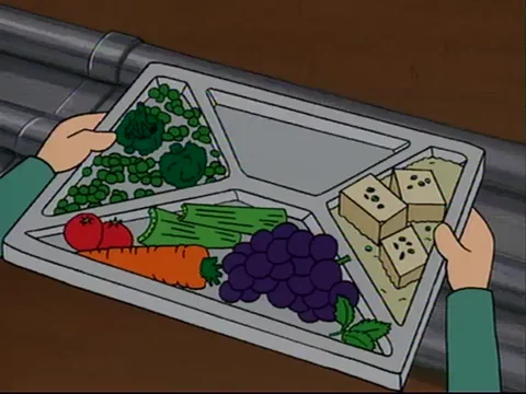 A cafeteria tray being filled with healthy food like vegetables, fruits, and tofu.