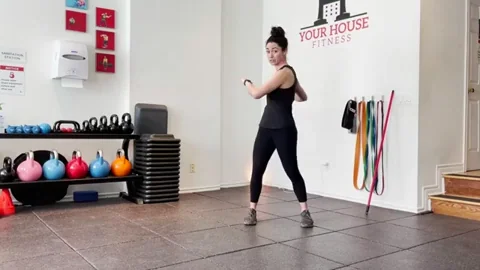 A woman performing dynamic movements in the gym.