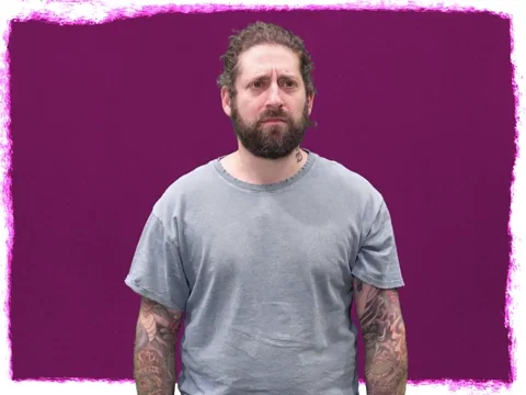 A confused looking man with white question marks hovering above him. 