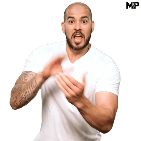 A bald man with a beard is clapping his hands and saying 'let's go'.  