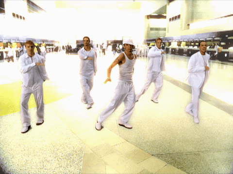 Backstreet Boys throwback dance GIF. They are wearing all white and doing a synchronized dance. 