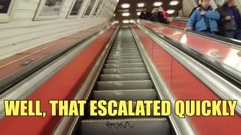A point of view shot of a person riding up an escalator. The text reads, 