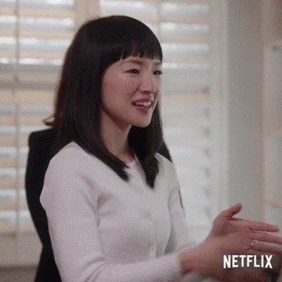 Marie Kondo giving a slight bow to someone.