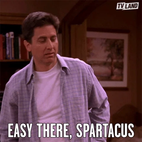 Ray Romano wearing a collared plaid shirt. He says, 