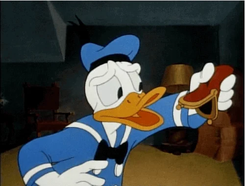 Donald duck shaking out his coin purse only to find there's nothing there.