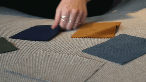 A person choosing carpet fabrics