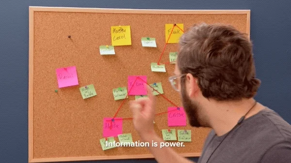 A person gathering information on a cork board with sticky notes. Text: Information is power.