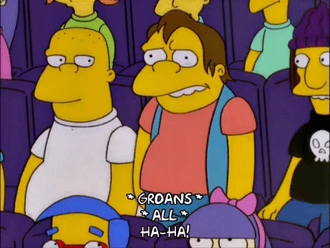 Characters from The Simpsons all point and laugh at Nelson Munce during a school assembly.