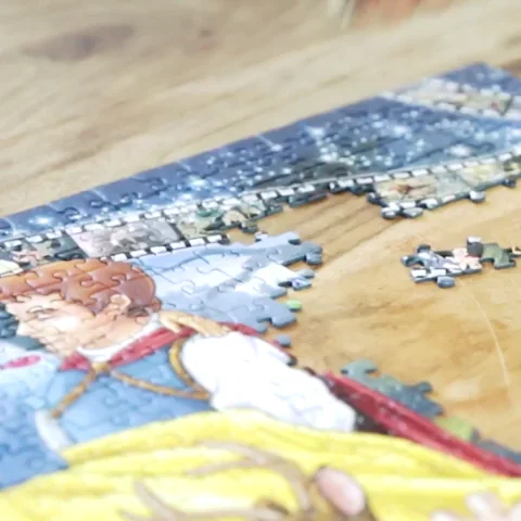 A person's hand trying to fit a piece into a puzzle.