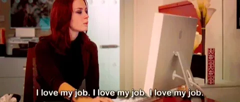 A woman sitting at a desk, looking at her computer, saying, 