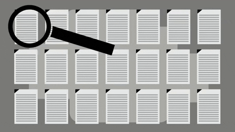 A magnifying glass looking at digital documents. The glass stops on a document and focuses on the words 'fake news'.