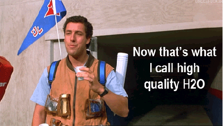  Adam Sandler drinking a cup of water and saying, 
