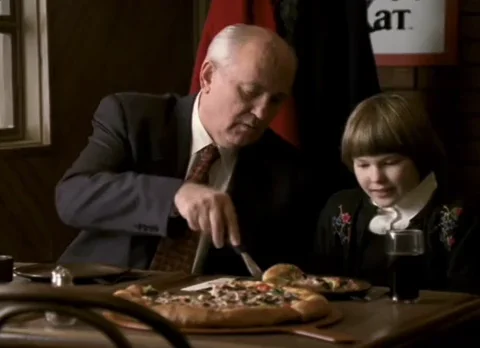 Gorbachev sharing a pizza with a young child.