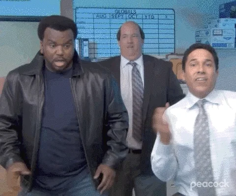 The cast of the show The Office dancing.