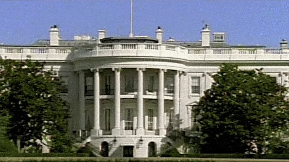 A series of news clips from the Cold War: the White House, a Soviet parade, missiles launching, and soldiers marching.