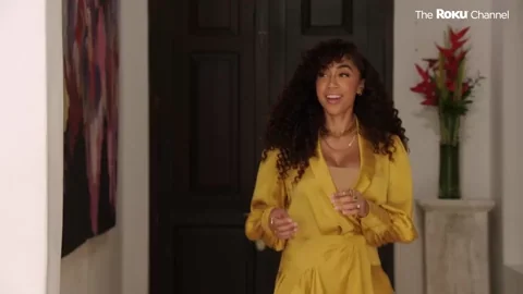 A person arriving at a local community event and greeting others with a hello.