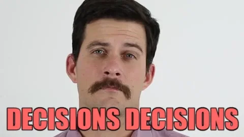 A man with a moustache saying, 'Decisions decisions!'