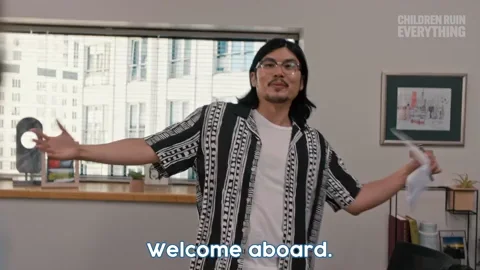 A man in an office holds out his arms and says, 