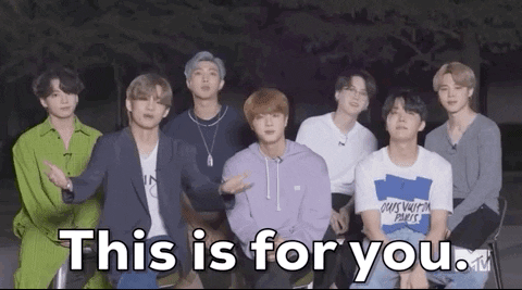 seven members of bts pointing at the viewer with the text 
