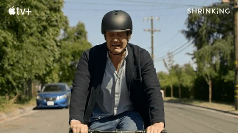 A man riding a bike while crying.
