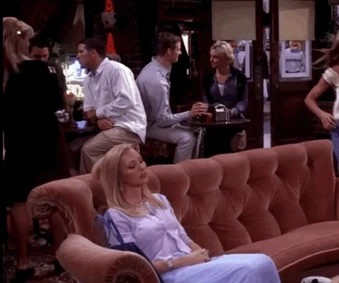 Phoebe from the show Friends sits on a couch. She says, 