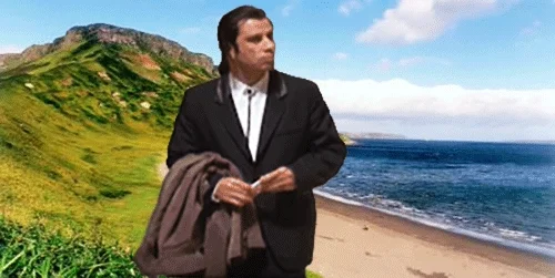 John Travolta circa Pulp Fiction looking around, confused. Poor CGI background of a beach and small mountain.