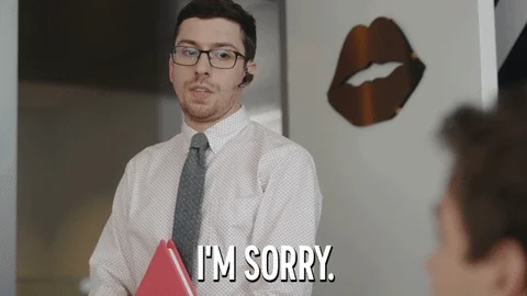 A man saying 'I'm sorry' with a look that he doesn't mean it.