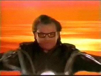 Jack Black wears sunglasses in front of a sunset. He says, 'Knowledge is power.'
