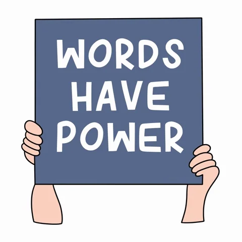 A person holds up a sign that reads: “Words Have Power