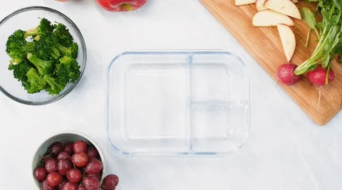 An animation of a nutritious, balanced meal appearing in a lunch container.