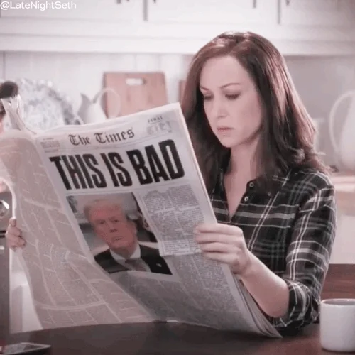 A woman reading the paper with the headline, 'This Is Bad.'