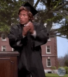 Dwayne Johnson wearing a black graduation cap and robe, cheering.