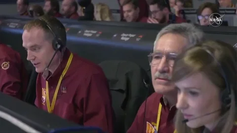 The NASA team cheering and giving each other high-fives.