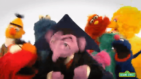 Sesame street characters dancing happily then they look up and the camera shows a number 2 above them.