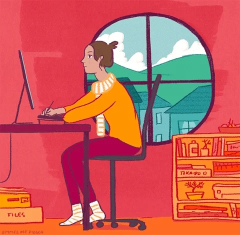 A woman sitting at a desk working as the sun rises and sets in the window behind her.