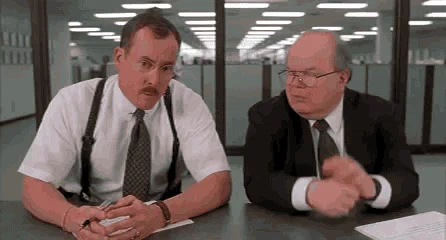 Two characters from Office Space at a desk. One asks, 