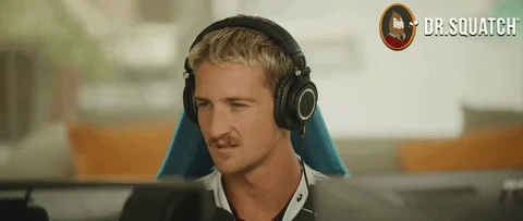 A tech industry employee at his desk looks deep in thought, then smiles as he makes a realization.