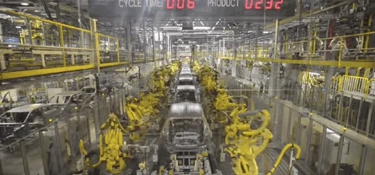 A car factory with a lot of automation machines.